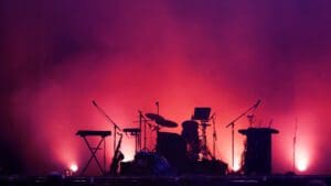 concert stage on rock festival, music instruments silhouettes, colorful background with copy space