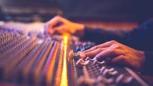 male producer, sound engineer hands working on audio mixing cons